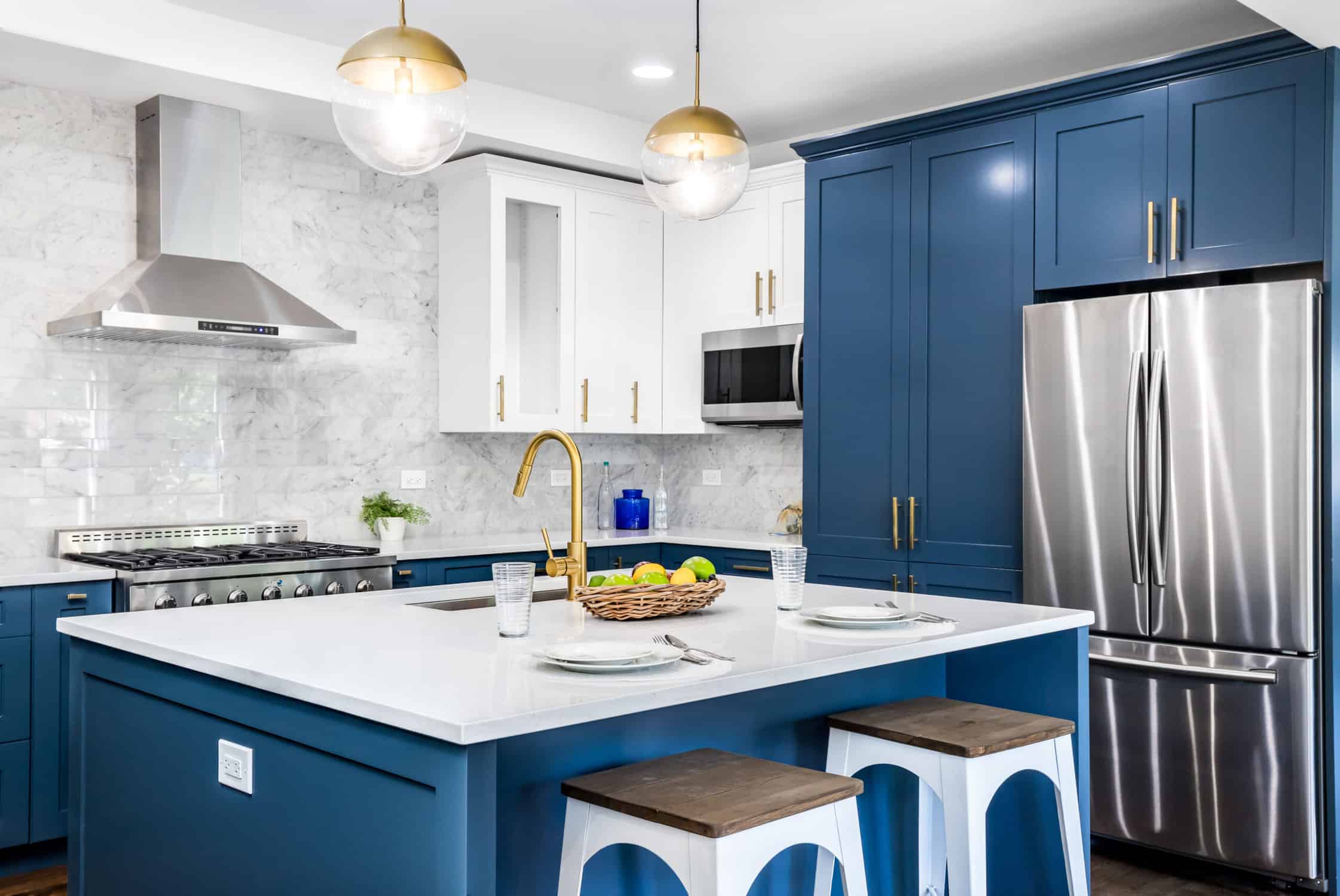 A blue kitchen with stainless steel appliances. Kitchen where you can use any cabinet painting techniques.